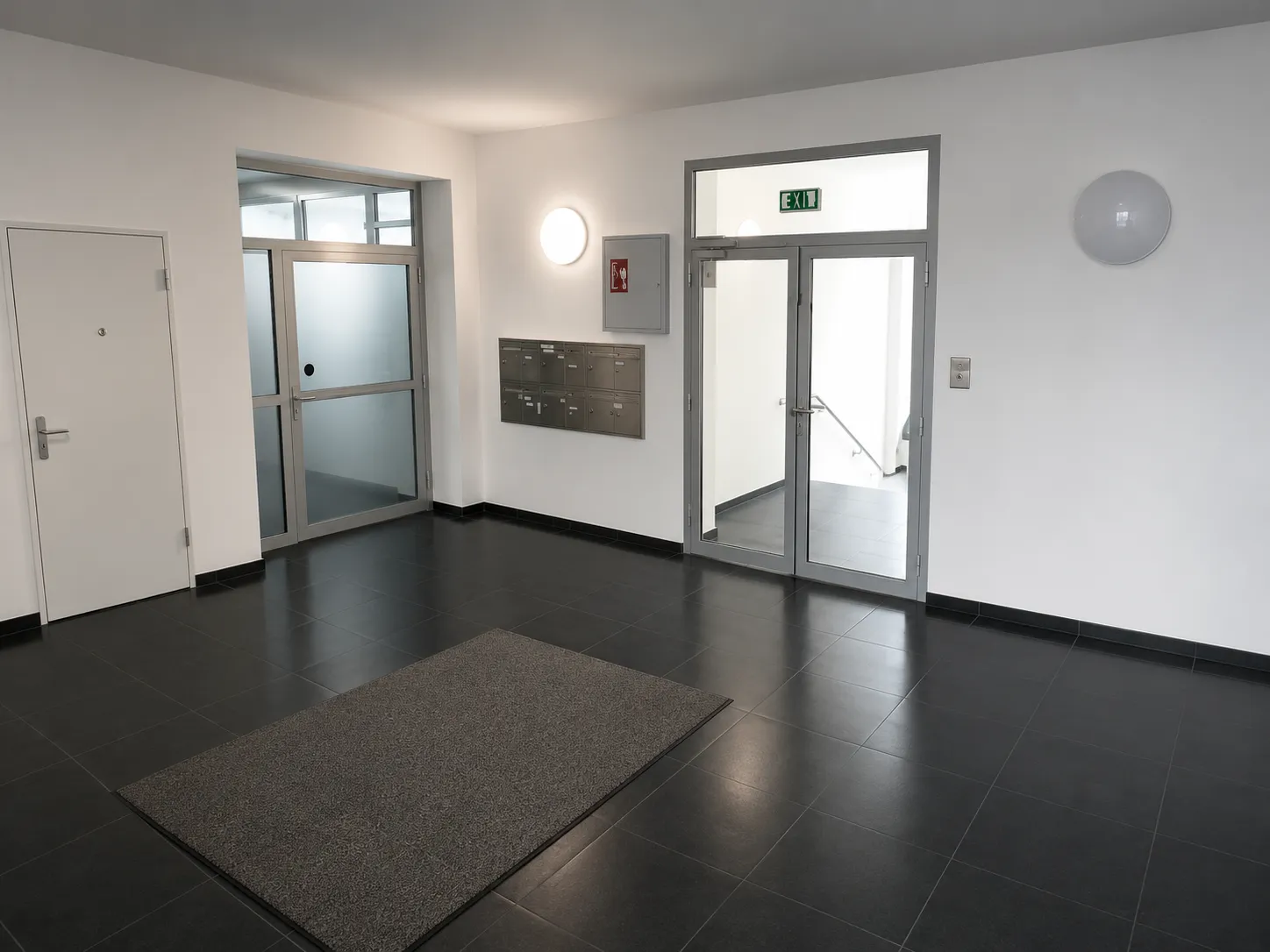 Professioneller Eingangsbereich mit Briefkästen und Zugangskontrolle